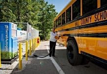 School employee fuels a propane school bus.