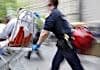 Paramedic rushes patient to the hospital on a stretcher.