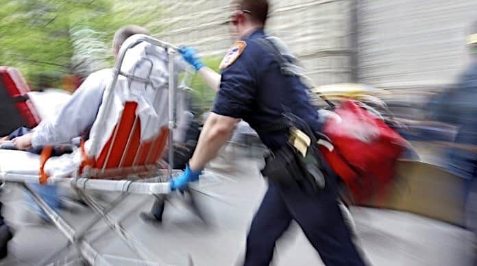 Paramedic rushes patient to the hospital on a stretcher.