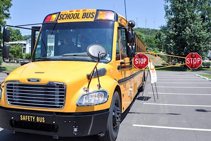 A West Virginia pilot program compared a regular stop arm sign with one that extends another six feet from the side of the bus.