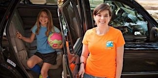 A HopSkipDrive employee with a student.