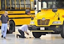 A participant inspects a tire during the 2015 America’s Best School Bus Inspection Skills & Training Competition in Kansas City. Photo By Mike Bullman.