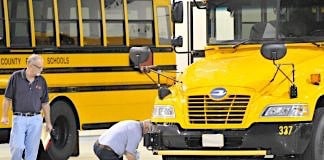 A participant inspects a tire during the 2015 America’s Best School Bus Inspection Skills & Training Competition in Kansas City. Photo By Mike Bullman.