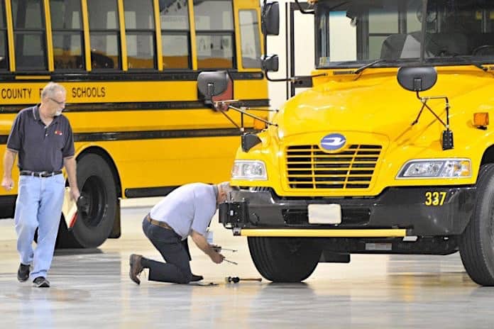 A participant inspects a tire during the 2015 America’s Best School Bus Inspection Skills & Training Competition in Kansas City. Photo By Mike Bullman.