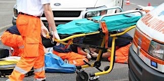 Paramedics tend to a victim on the road.