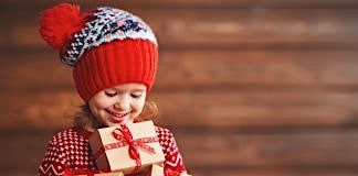 Girl holds Christmas presents