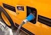A electric school bus being charged. Interest in electric is expanding across the U.S.