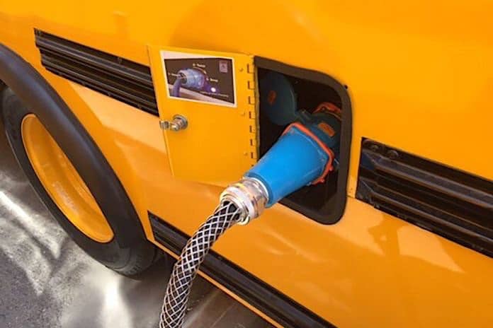 A electric school bus being charged. Interest in electric is expanding across the U.S.