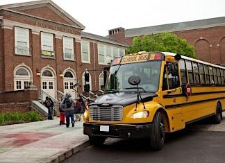First Student, Inc. bus arrives at an elementary school.