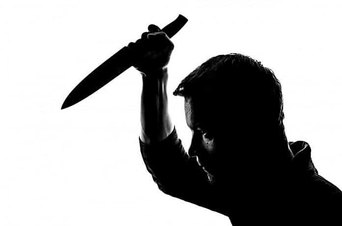 Silhouette of man wielding knife