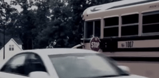 Car passing a stopped school bus