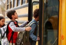 Students boarding school bus. Shutterstock photo.