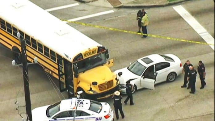 A driver with a gunshot wound crashed into a school bus while children were on board. (Photo from WTRK)
