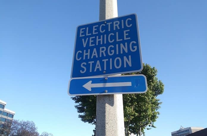 Sign showing direction of closest electric charging station.