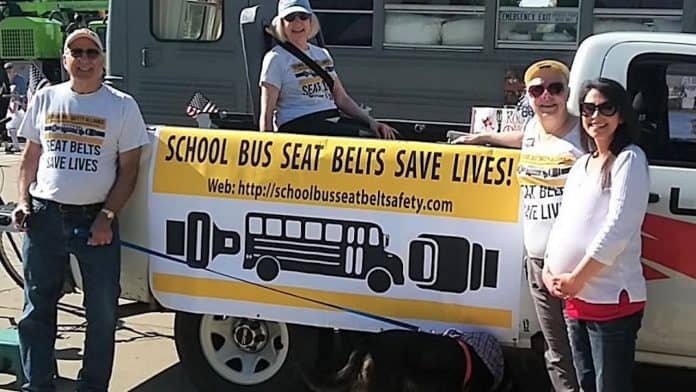 The School Bus Safety Alliance designed a colorful banner to help campaign for seat belts in school buses, at the Avon Lake Memorial Day Parade in Ohio. (Photo courtesy of cleveland.com.)