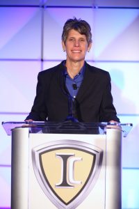 Trish Reed stands at a IC podium 