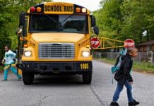 School bus using the extended stop arm with children present