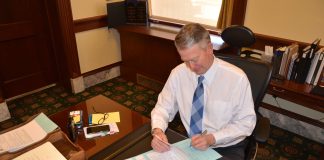 Gov. Little signing proclamations.