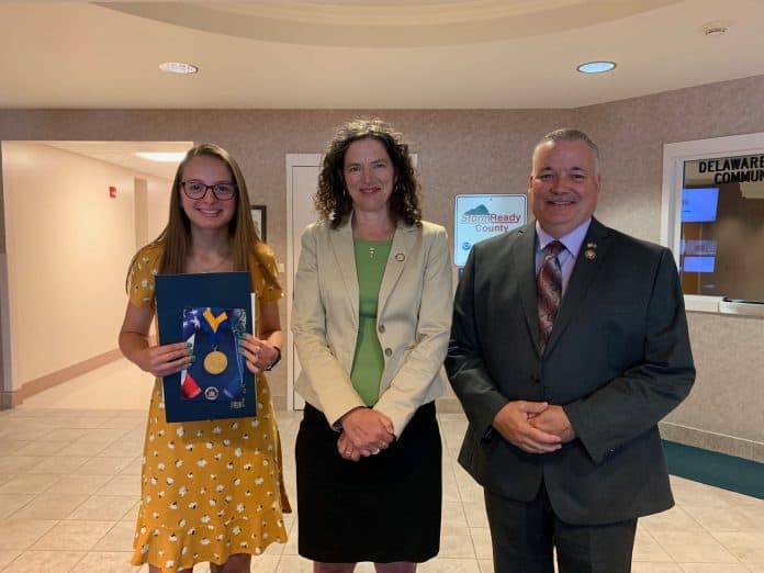 Sen. Jen Metzger, center, awarded the New York State Liberty Medal to 14-year-old Rachel Trimbell. Trimbell, left. Also pictured is Delaware County Sheriff Craig DuMond, who presented another award to Trimbell in May.