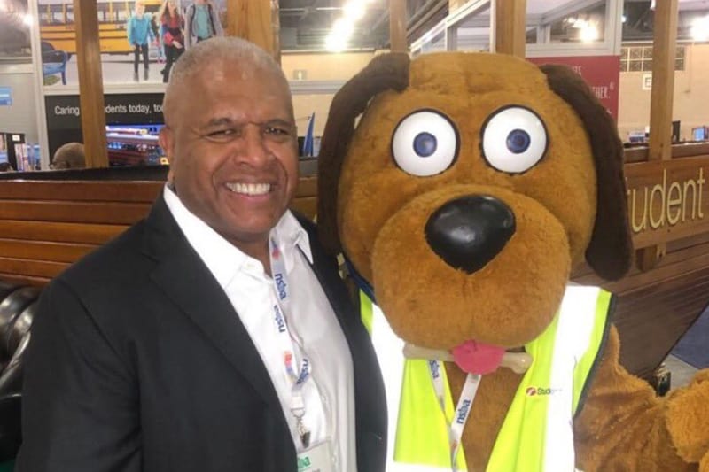 Dennis Maple with First Student mascot Safety Dog.