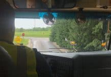 inside of school bus, looking over school bus driver's shoulder