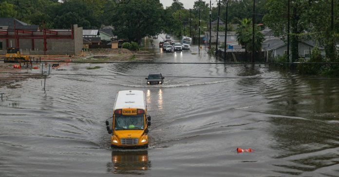 A school bus driving through flooded roads on Sept. 19 in Houston. Hurricane Imelda reportedly dumped 40 inches of rain in over 72 hours. (Photo: Thomas B. Shea/Getty Images.)