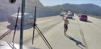 Screen capture of Fox 11 footage of an almost naked man running towards a school bus driving on I-5 in the Los Angeles-area this week.