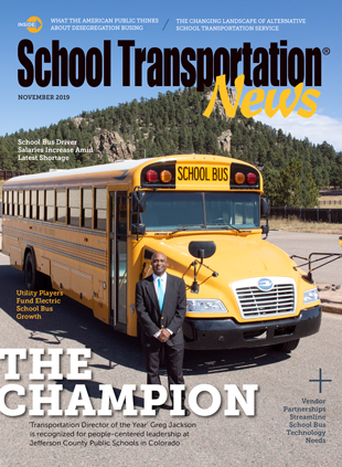 Greg Jackson of Jefferson County Schools poses with a Blue Bird School Bus