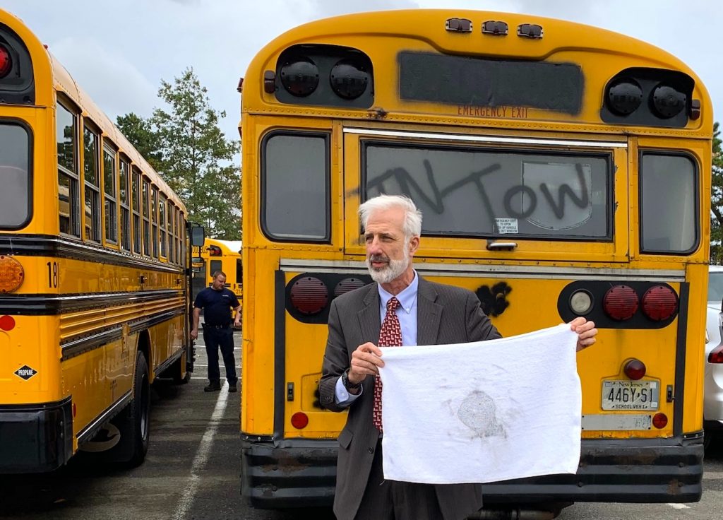 EPA Deputy Regional Administrator Walter Mugdan displayed the results of a white towel test on a 1998 diesel-powered bus that is set to be scrapped as part of the replacement program.