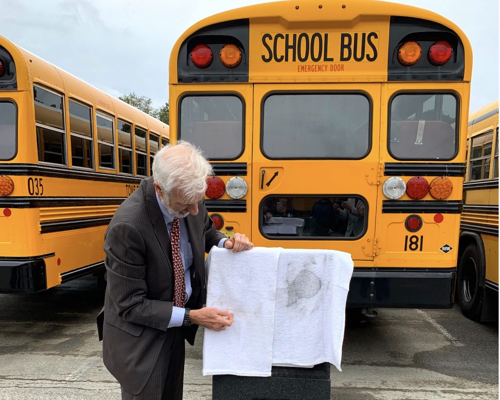 EPA Deputy Regional Administrator Walter Mugdan compared the two test results; the new clean bus towel on the left versus the dirty old bus towel on the right.