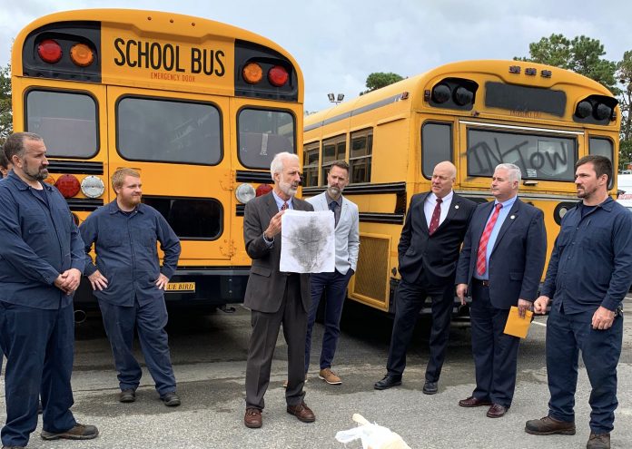 EPA Deputy Regional Administrator Walter Mugdan displays a dirty hanky from the tailpipe emissions of a 1998 diesel-powered bus.