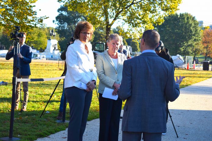 From left, Reps. Jackie Walorski and Julia Brownley listen as Chris Akiyama from Safe Fleet shares information on the company's Predictive Stop Arm technology to warn students and bus drivers when a motorist is not stopping during a technology demonstration in October 2019 following the introduction that spring of the STOP for School Buses Act.