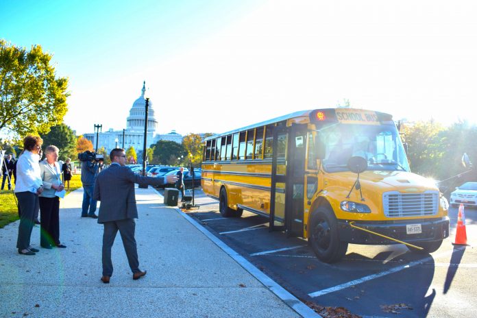 A bipartisan group promoted School Bus Safety Week by highlighting efforts to prevent illegal passing. Shown are Reps. Walorski and Brownley, with Chris Akiyama from Safe Fleet in the foreground.