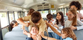 Stock photo of student bullying on a school bus.