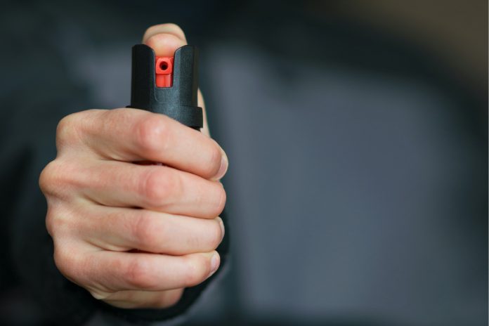 Stock photo of someone holding pepper spray.