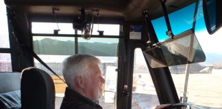 Dave Hartzell, director of transportation for Harrison School District 2 driving a school bus.
