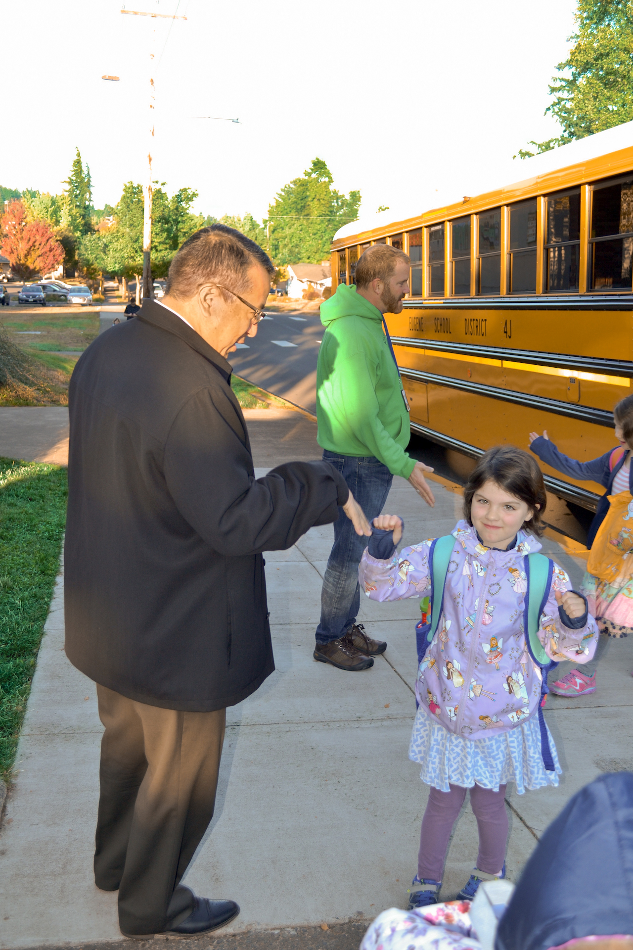 Gustavo Balderas, superintendent for Eugene School District 4J, and a student about to board a school bus. 