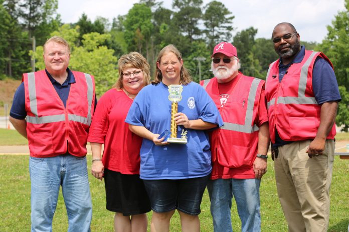 Newton County School Superintendent Samantha Fuhrey, second from left, congratulates 2019 district school bus roadeo winner Karen Jenkins. At far left is Director of Transportation Chad McCaskill. Randall Luna, transportation coordinator (second from right) stands next to David Flanigan, school bus safety and training supervisor.