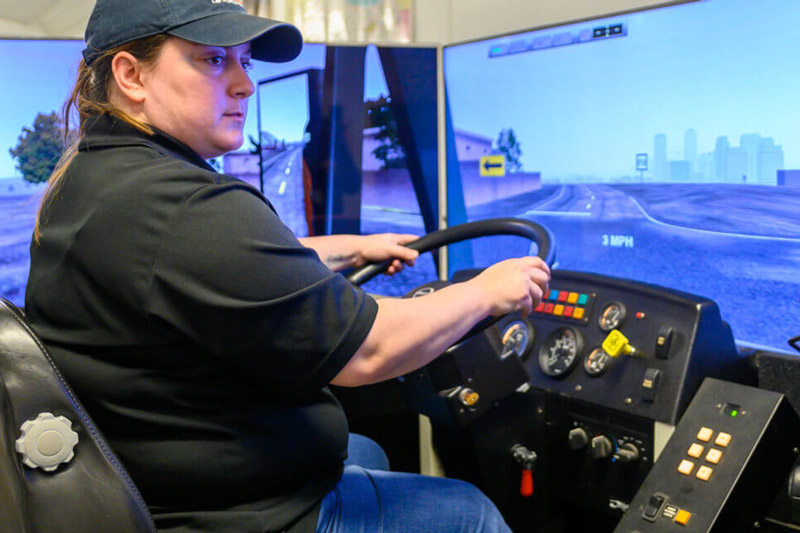 Klein ISD school bus driver Rashelle Wisnoskie takes the simulator for a spin. (Photo courtesy of Klein ISD)