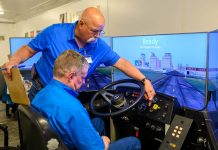 Larry Thorton, safety training specialist for Education Services Center Region 6 in Huntsville, Texas, shows a Klein ISD school bus driver how to operate the high-tech simulator. (Photo courtesy of Klein ISD)