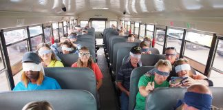 School bus drivers at Dean Transportation in Michigan wear blindfolds as one of their coworkers drives the school bus. The empathy training helps the drivers to understand the challenges that students with disabilities might be facing while in the school bus environment. (Photo courtesy of Fred Doelker)