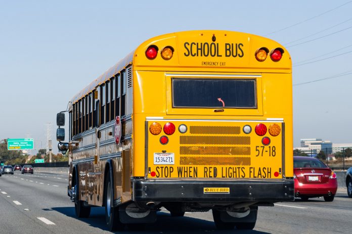 Stock photo of a school bus traveling down a highway near San Francisco.