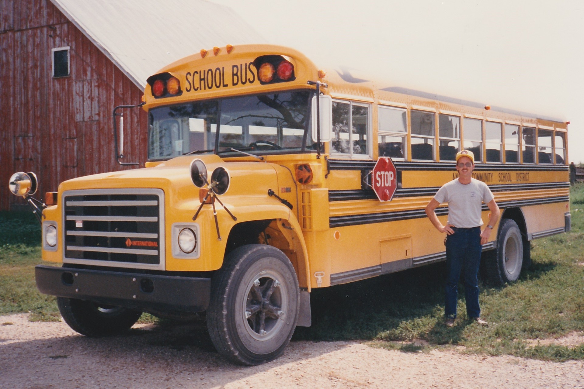 Max Christensen posing with his second school bus at Anita Community Schools in 1988.