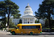 A March 2014 file photo of an early electric school bus parked in front of the state capitol building in Sacramento, California. (Source: Wikimedia Commons/Urvashi Nagrani)