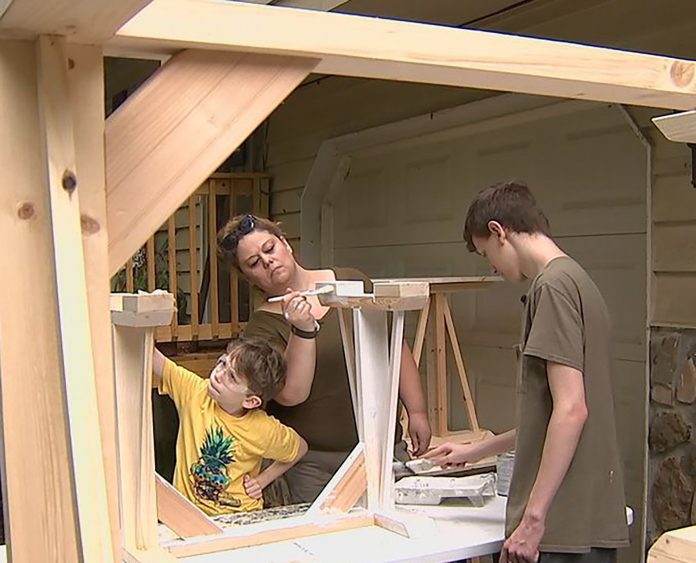 Michelle Minor and her two sons build desks for students who are online learning during the coronavirus pandemic. (Photo courtesy of Michelle Minor.)