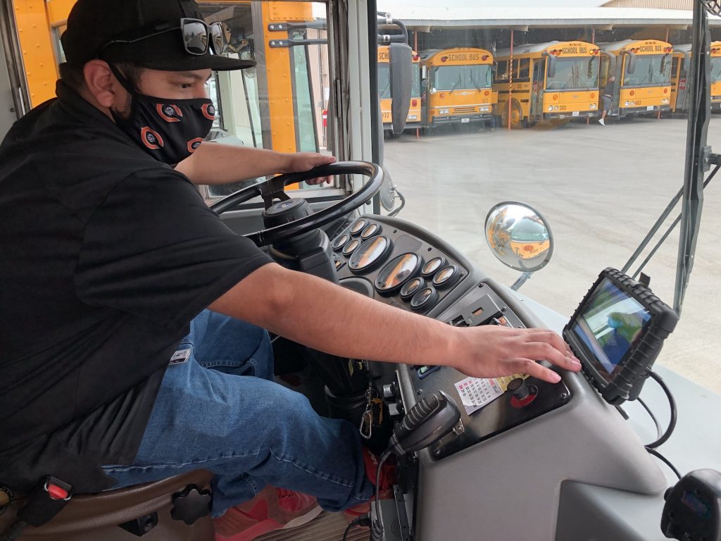 School bus driver Luis Oliva operates a tablet for Coalinga-Huron Unified School District in California.