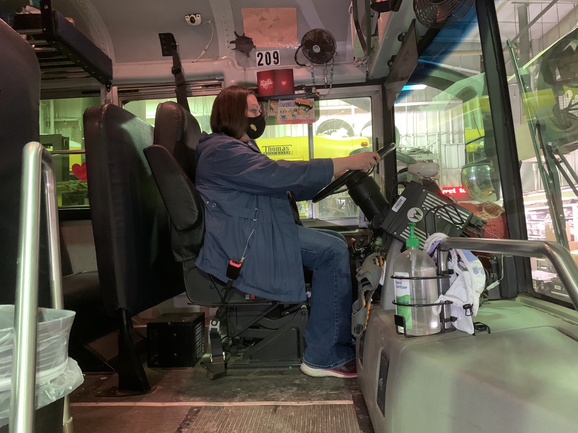 School Bus Driver Timarie Javier wears a face mask while sitting behind the wheel of a Campbell County School District bus in Gillette, Wyoming. The district started transporting students at the start of the 2020-2021 school year, with safety protocols in place to mitigate COVID-19 exposure.