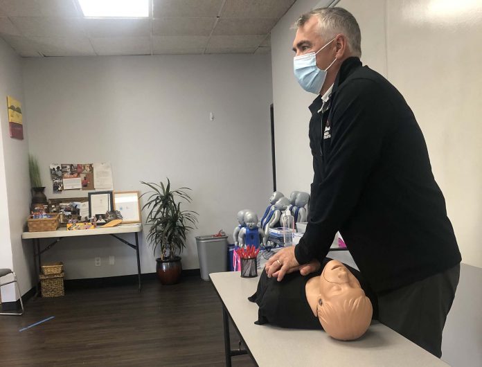 A-B-CPR owner Mike Long demonstrates proper CPR techniques on a mannequin during training for Oceanside Unified School District bus drivers in San Diego. (Photo courtesy of LeeAnn Conger.)