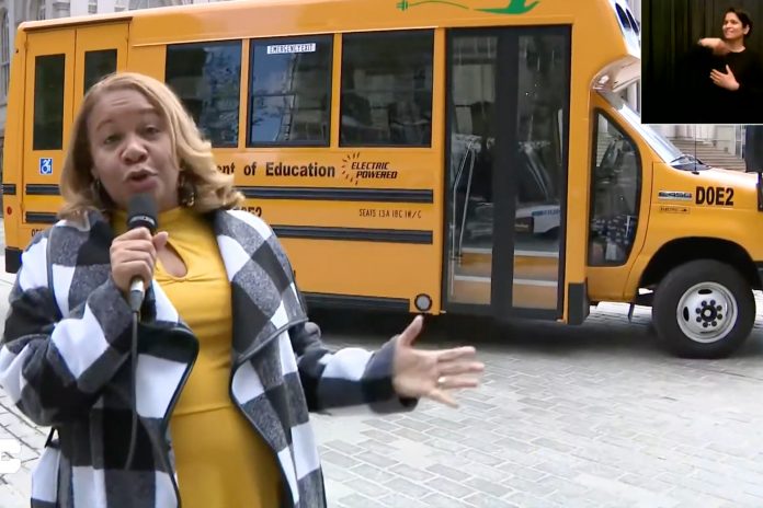 New York City Schools chancellor Meisha Porter shows off the first electric school bus that will begin transporting students next week.