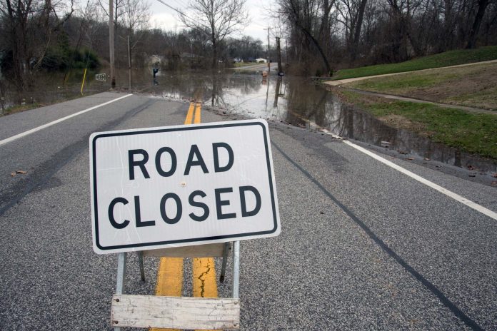 A road closed sign in the middle of a roadway in Oakville near St. Louis, Missouri